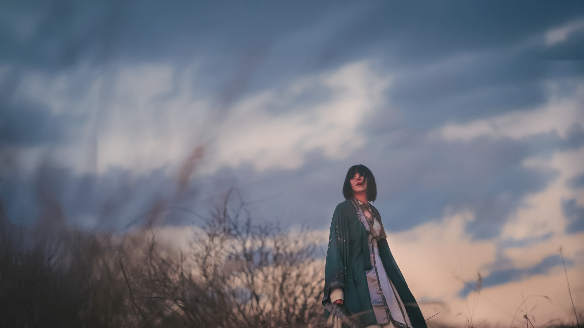 SUMI beneath a dramatic sky in the KOURO music video